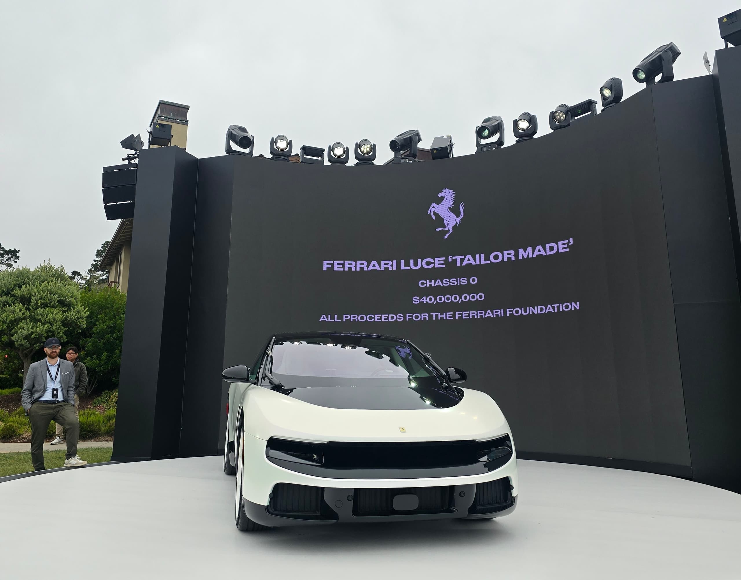 Ferrari Luce Chassis 0 on a Monterey Car Week stage beneath a Ferrari backdrop reading $40,000,000 for the Ferrari Foundation