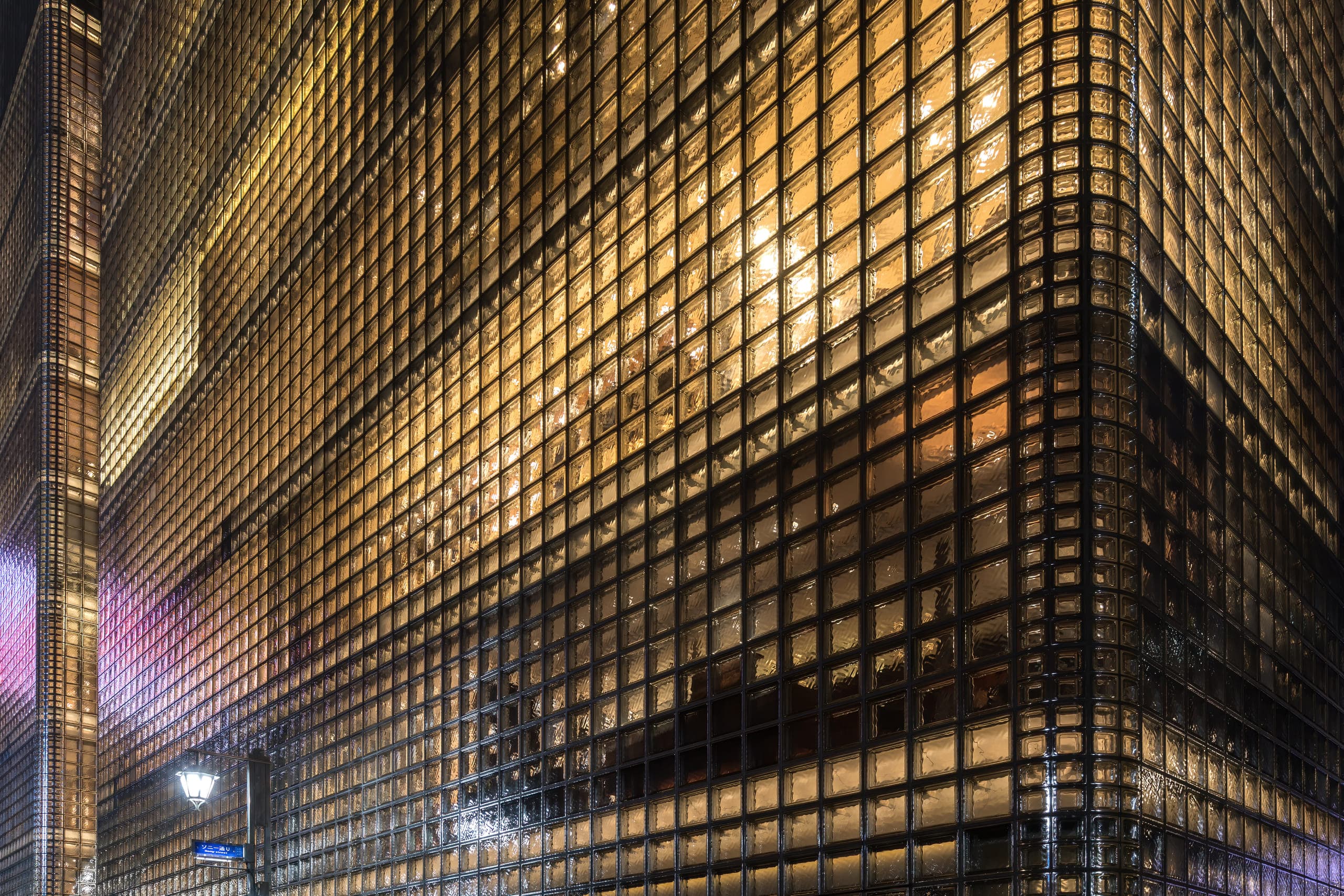 The illuminated glass-block corner of Maison Hermès in Ginza, Tokyo, at night