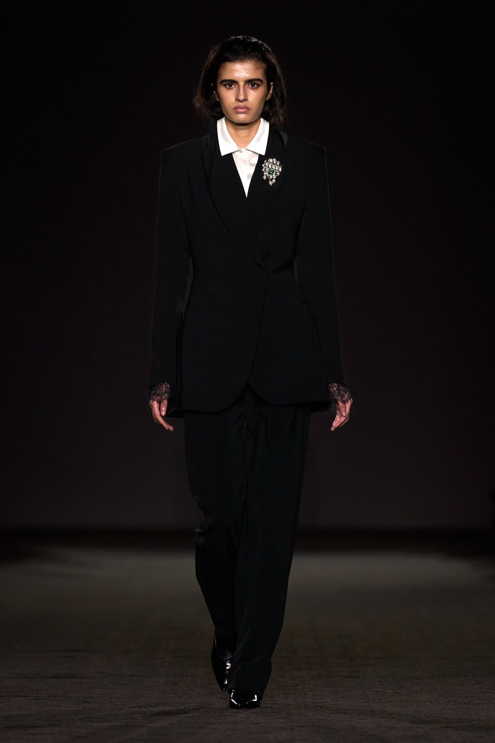 Black tailored suit with lace cuffs and emerald brooch, Prabal Gurung Fall 2026 runway