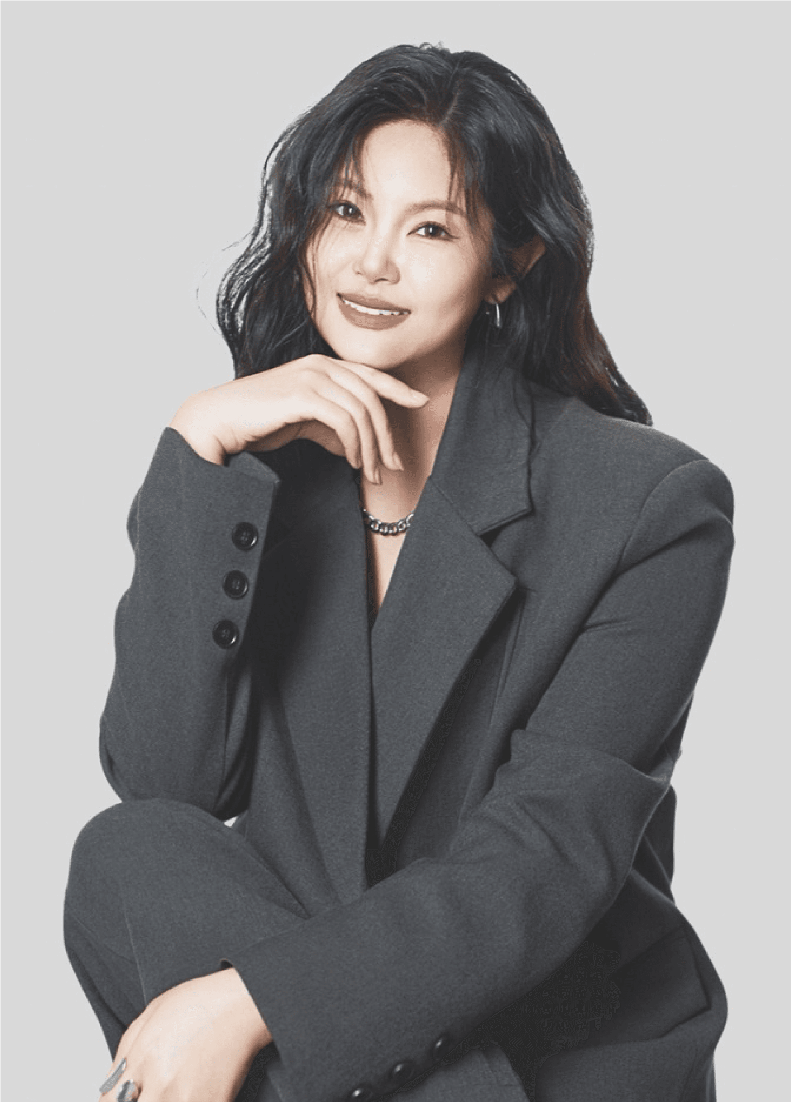 Studio portrait of Taiwanese perfumer Kaiwei Hsieh in a charcoal suit