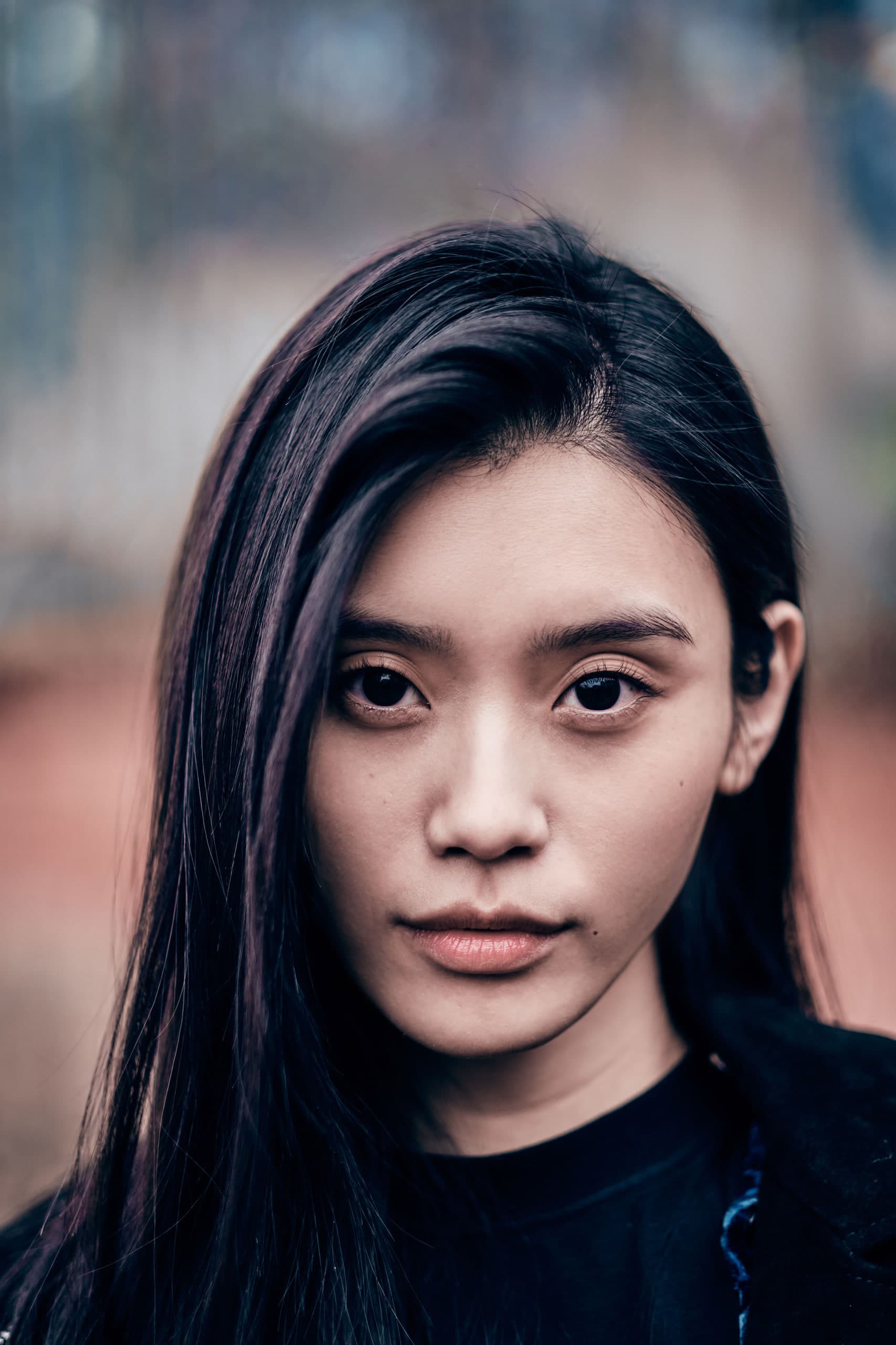 Ming Xi walking at Paris Fashion Week Autumn Winter 2019 in a black coat over a sheer black dress
