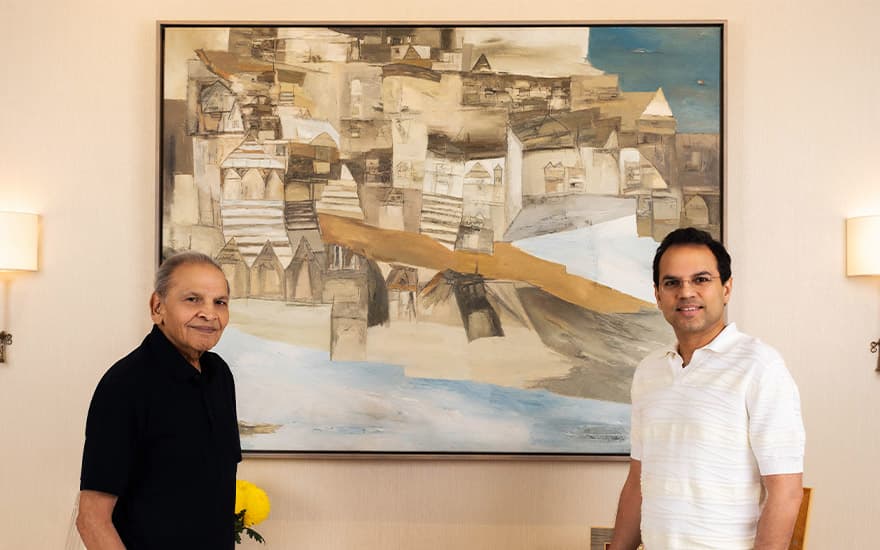 Rajendra Dabriwala and his son Surbhit standing in front of a cityscape by Ram Kumar