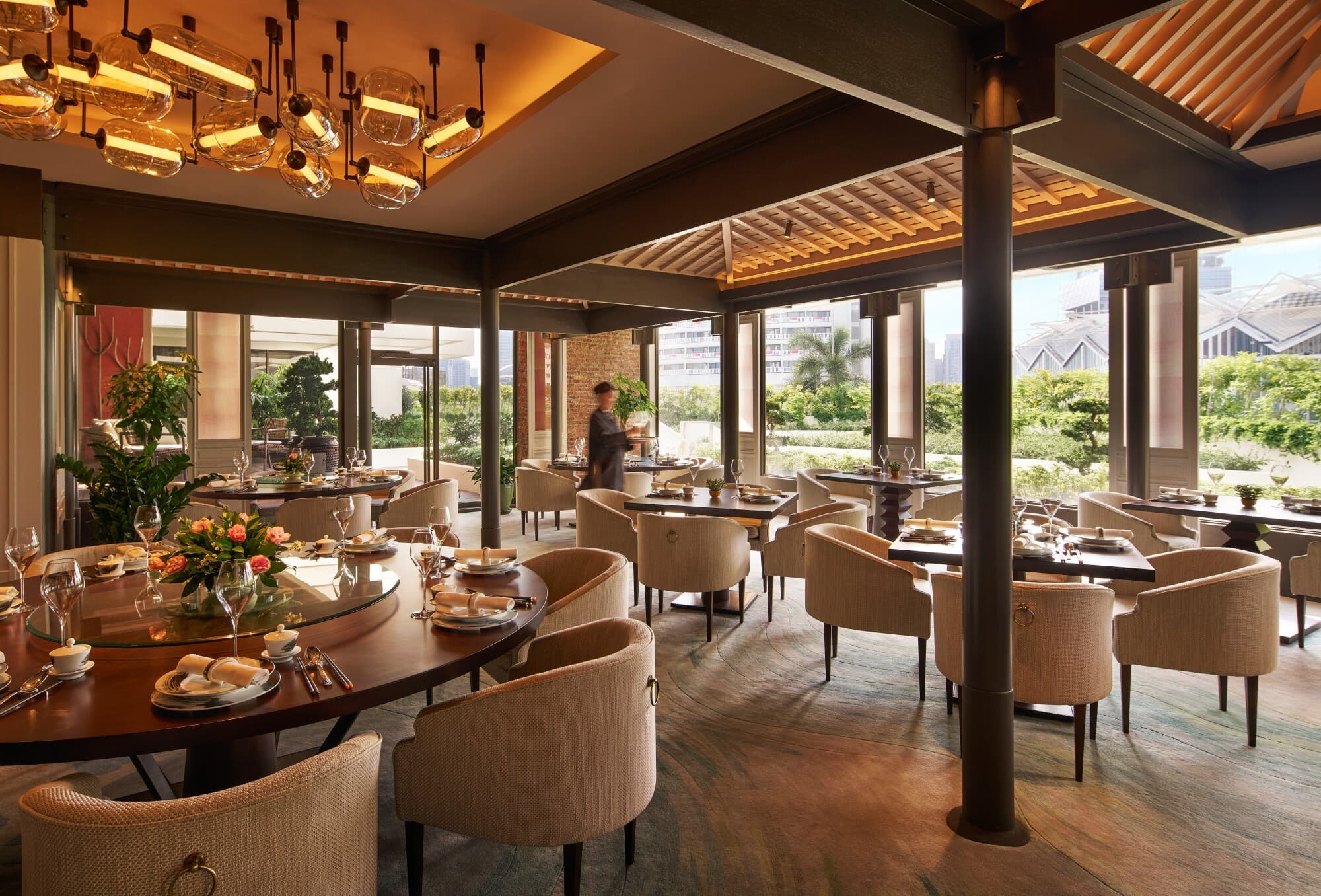 Round dining table with lazy Susan and garden view at Cherry Garden by Chef Fei, Mandarin Oriental Singapore