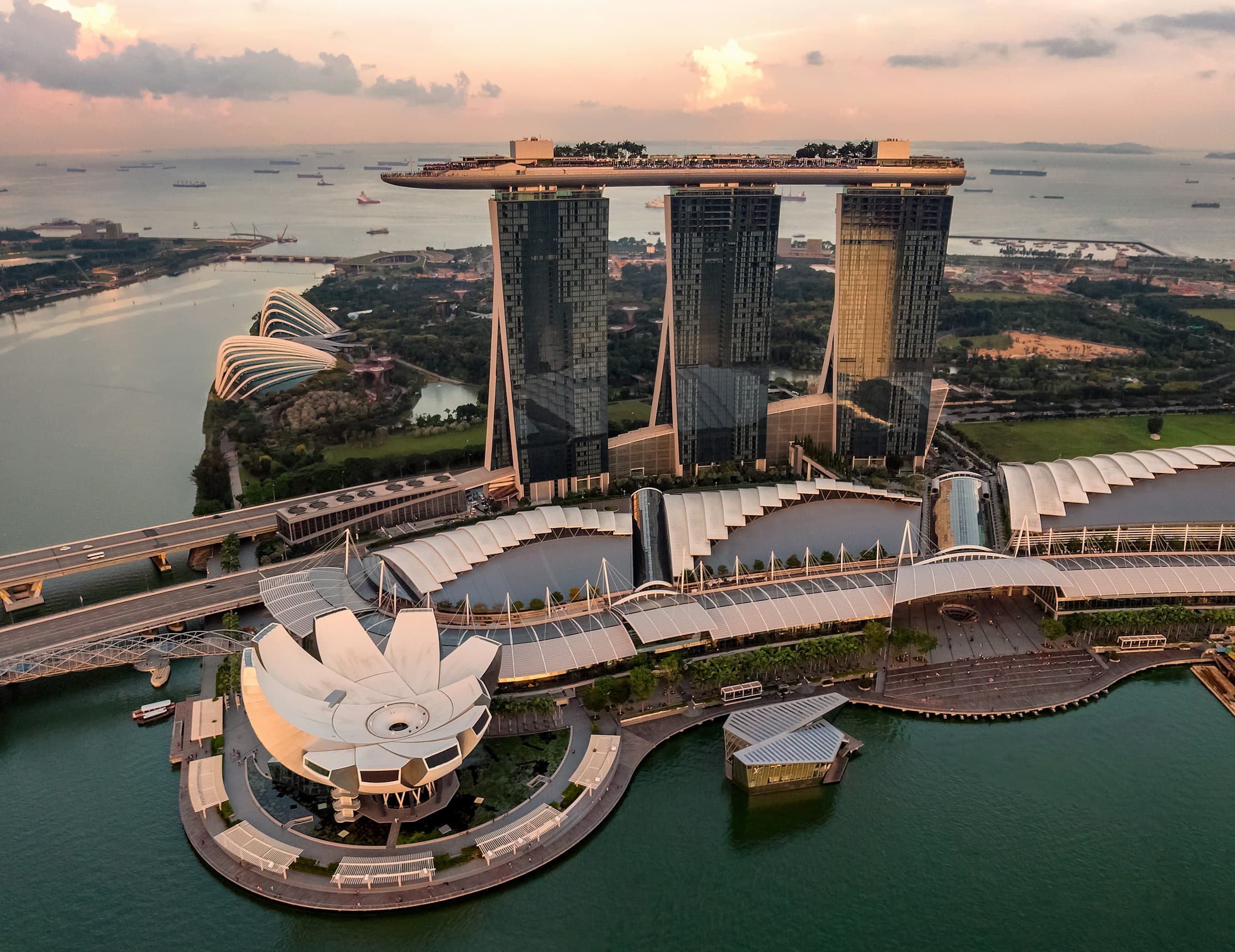 Marina Bay at dusk, with Marina Bay Sands, the ArtScience Museum, and the Gardens by the Bay glasshouses