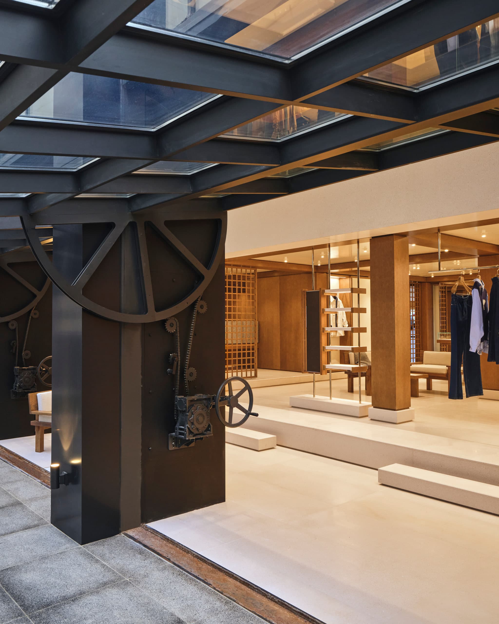 Entrance threshold of the Ami Paris Hannam-dong flagship in Seoul, looking into the oak and stone retail hall