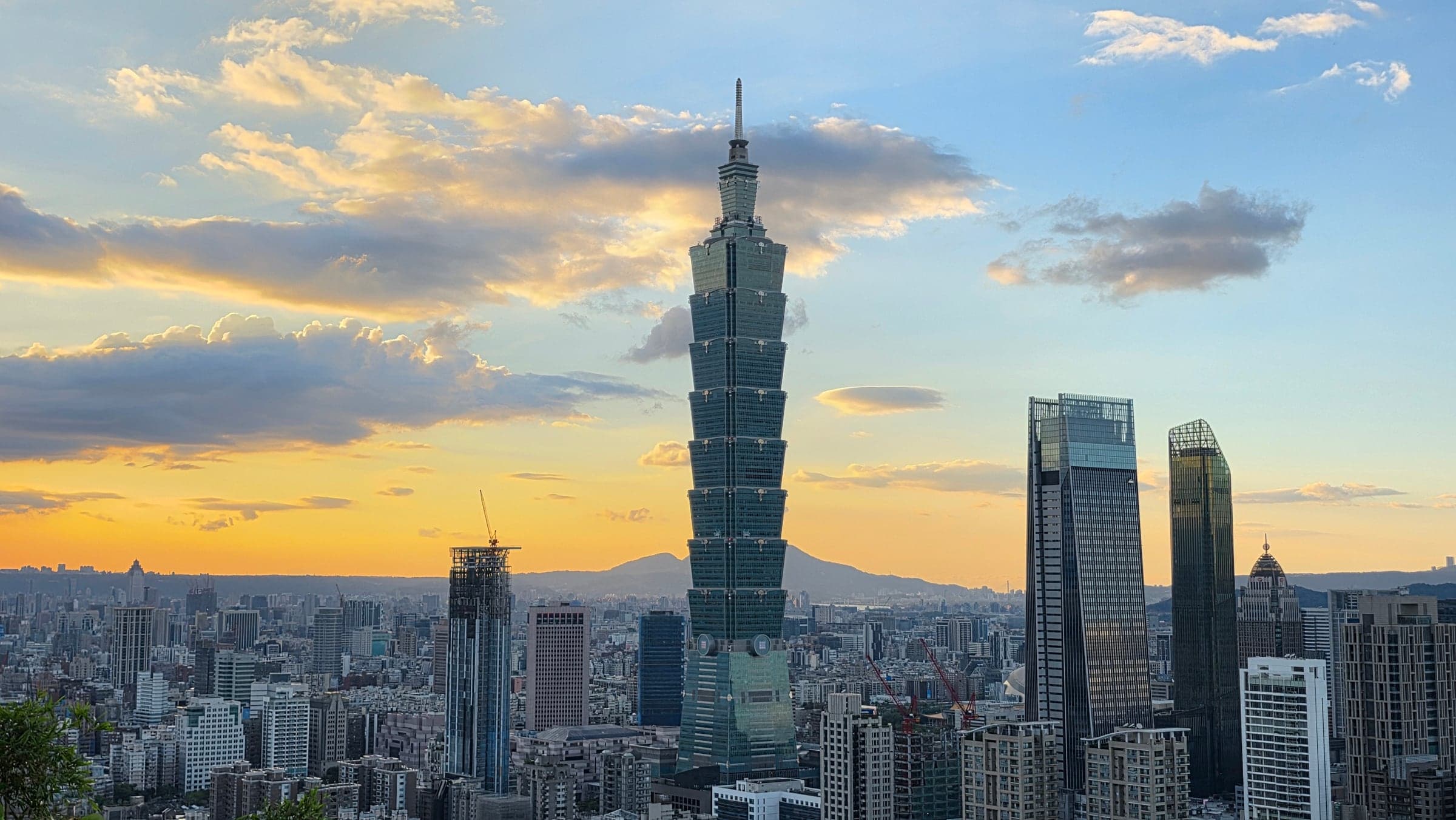 Taipei 101 and Xinyi skyline at golden hour from Elephant Mountain