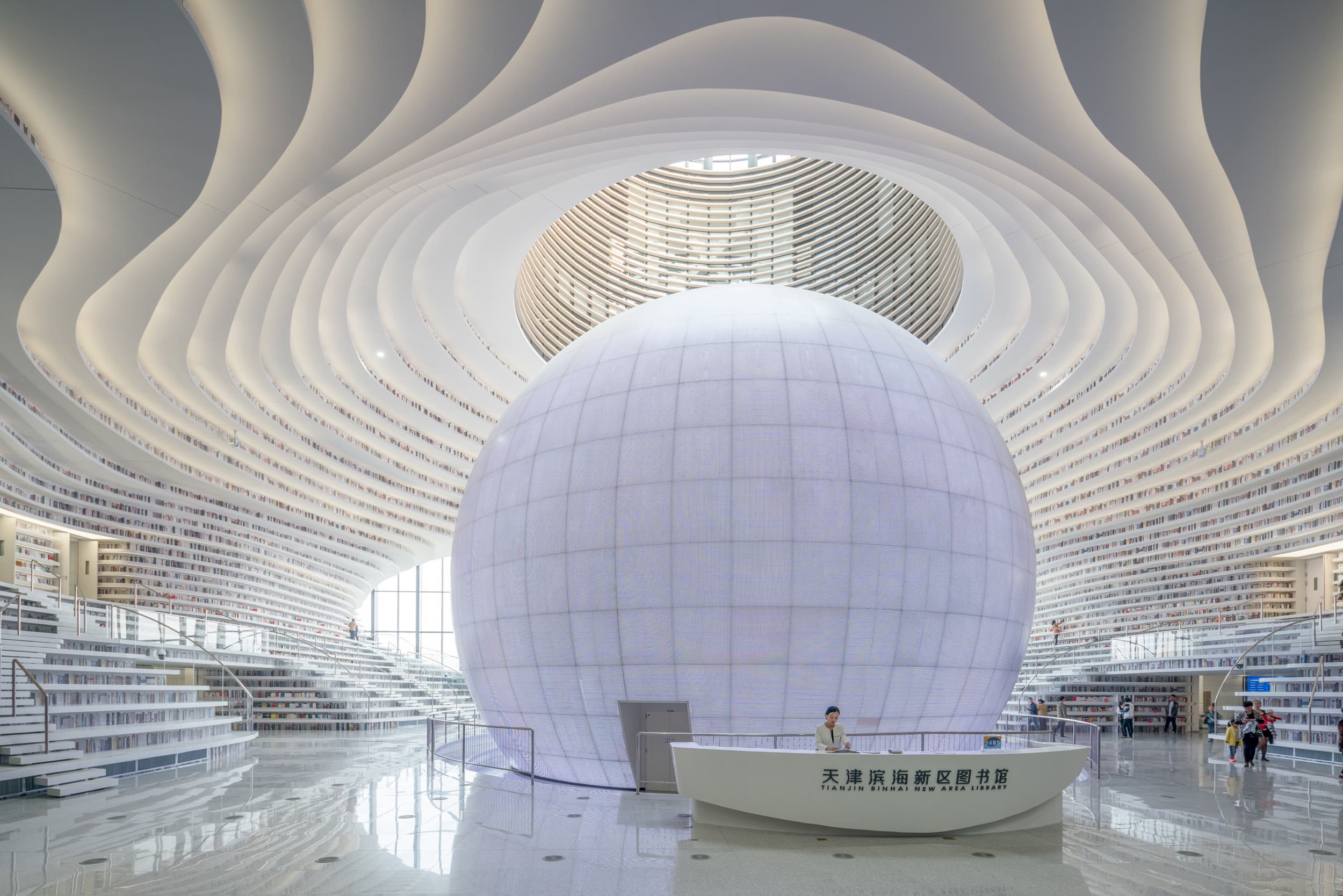 Luminous spherical auditorium and terraced central atrium of Tianjin Binhai Library
