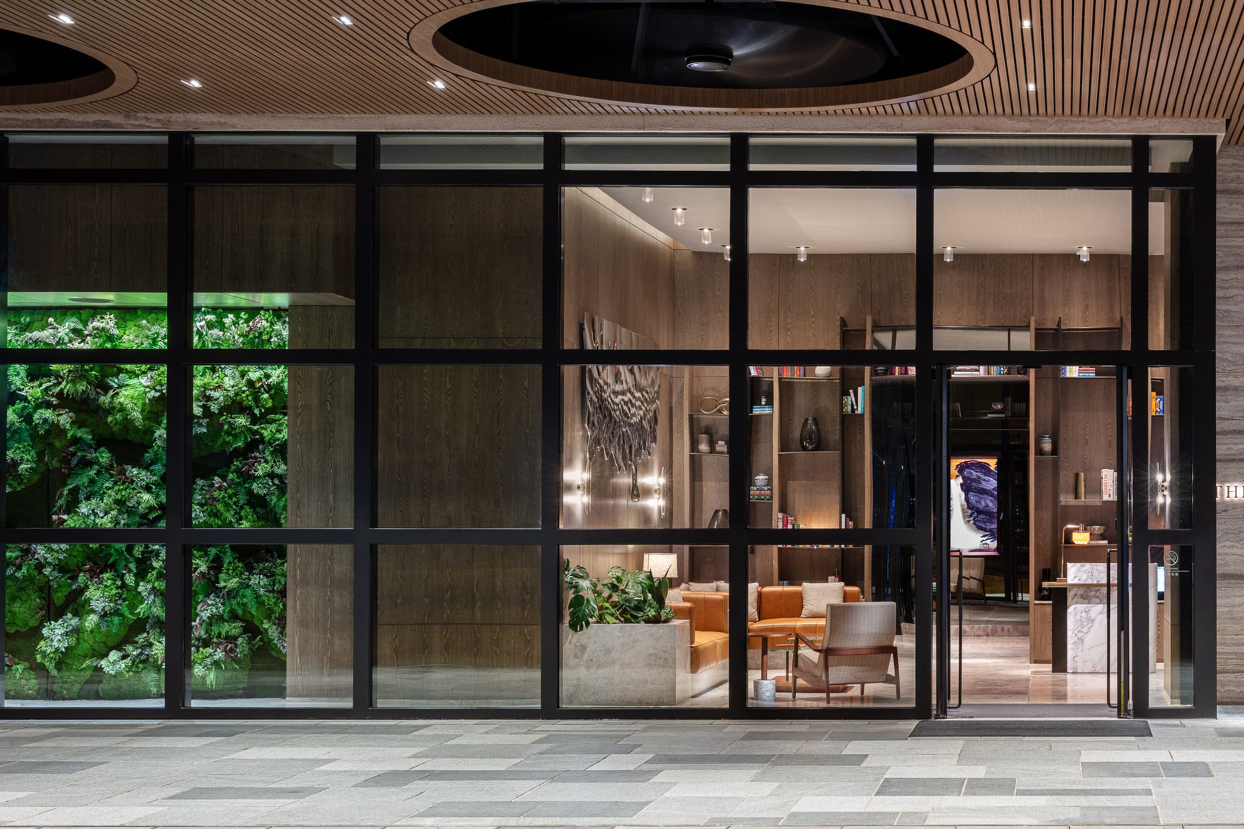 Glass entrance and living-wall lobby of The Hari Hong Kong in Wan Chai, designed by Tara Bernerd & Partners