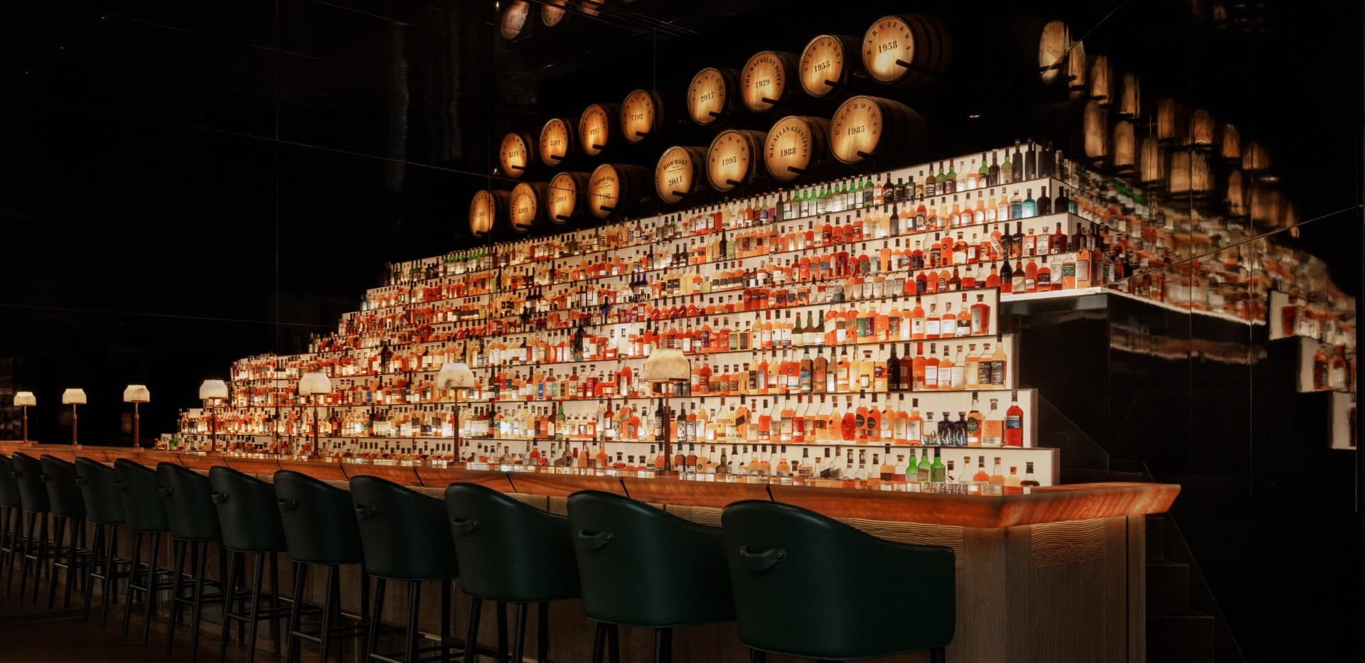 Illuminated whisky pyramid and glowing bar counter at Pony & Plume, Capella at Galaxy Macau