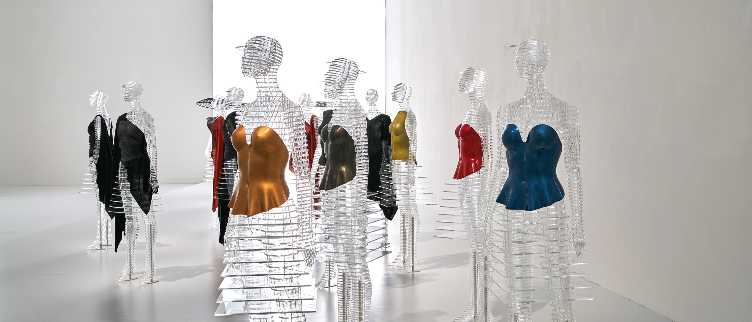 Tokujin Yoshioka grid-body mannequins wearing Issey Miyake Body series sculptural bodices in gold, blue, and red, National Art Center Tokyo 2016