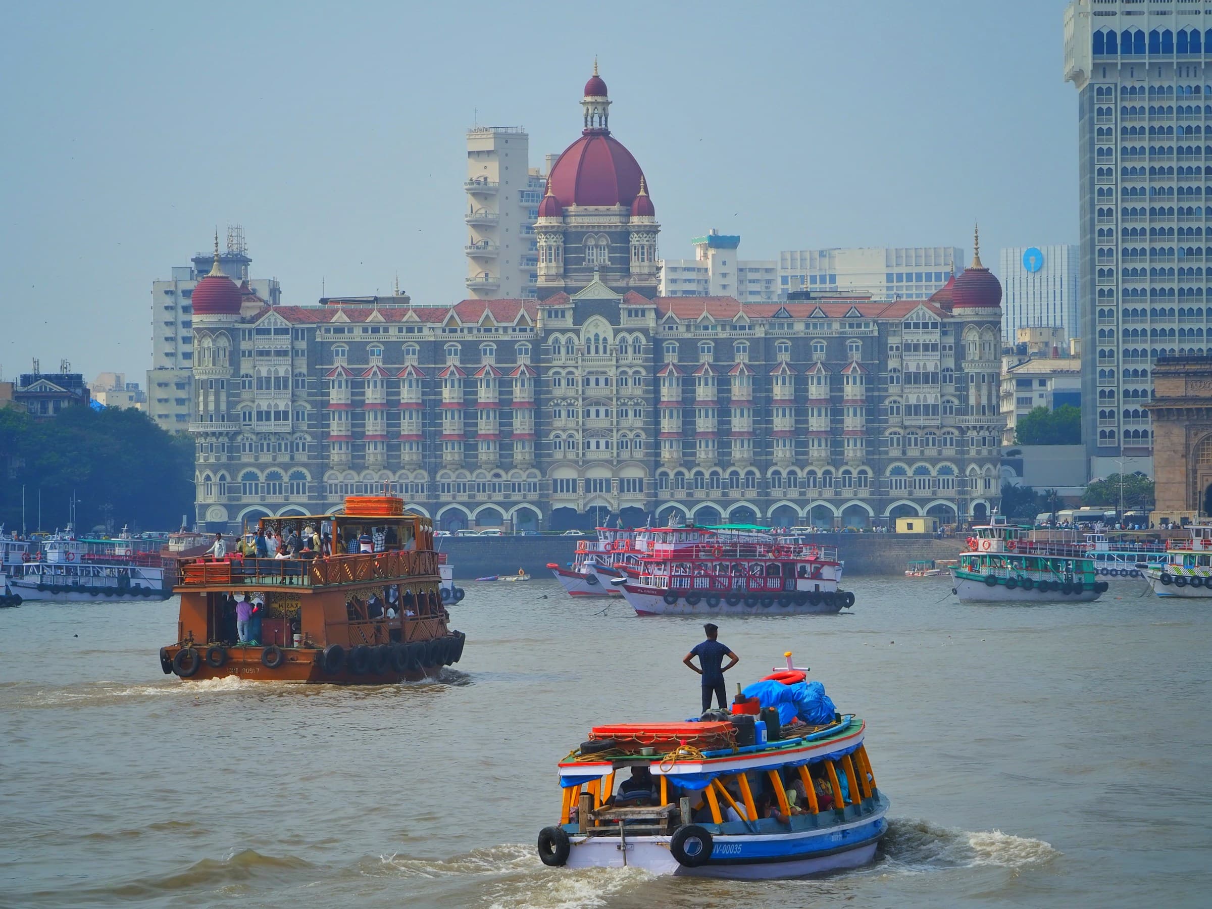 Mumbai harbour with boats and heritage architecture near the Gateway of India