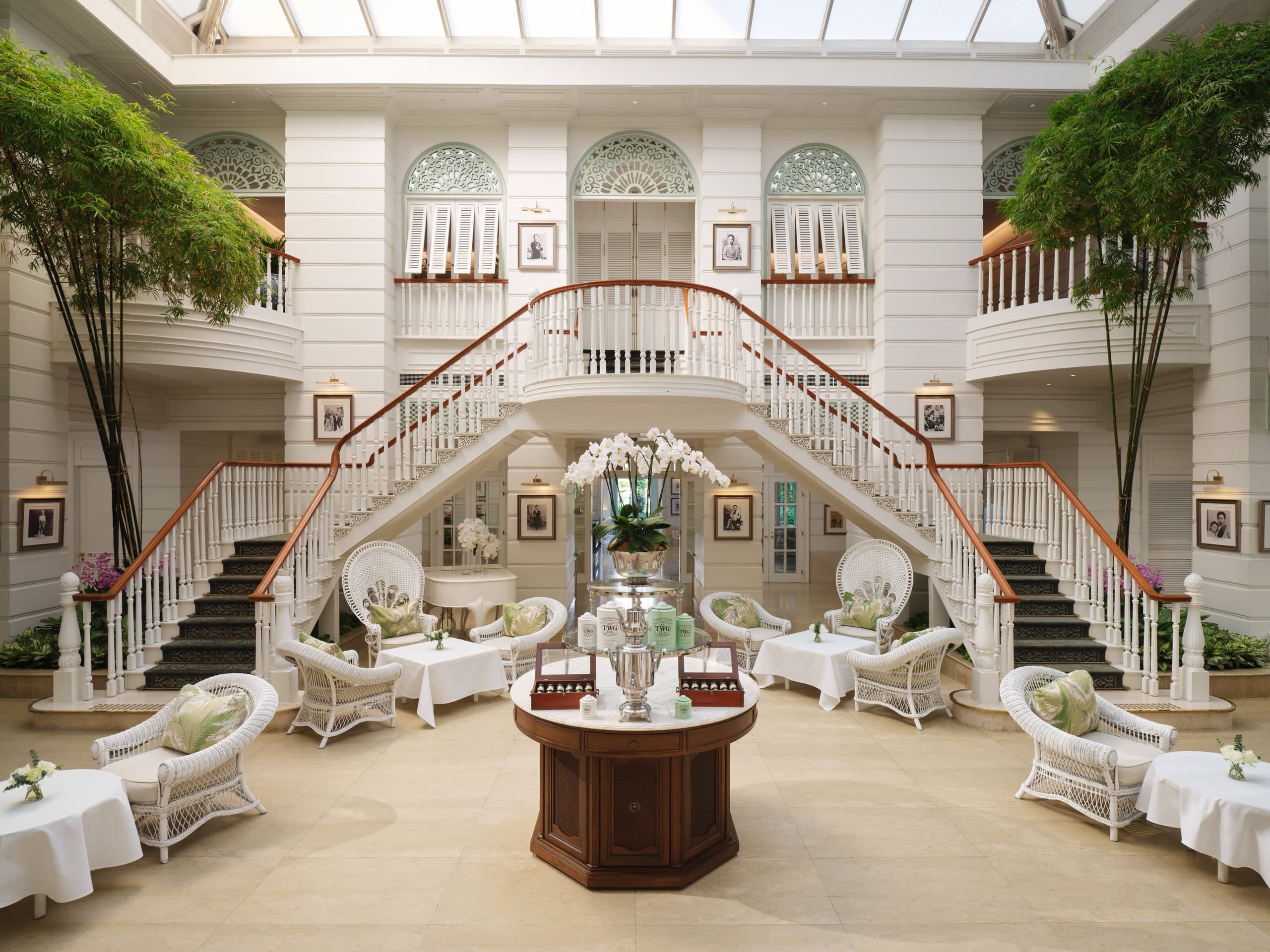 Authors' Lounge at Mandarin Oriental Bangkok with grand white staircase, wicker seating, bamboo, and skylight