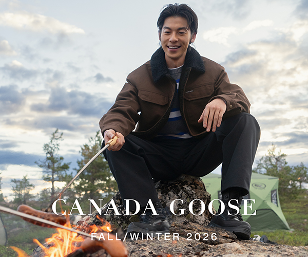Canada Goose Fall/Winter 2026 advertisement: a man in a brown jacket beside a campfire