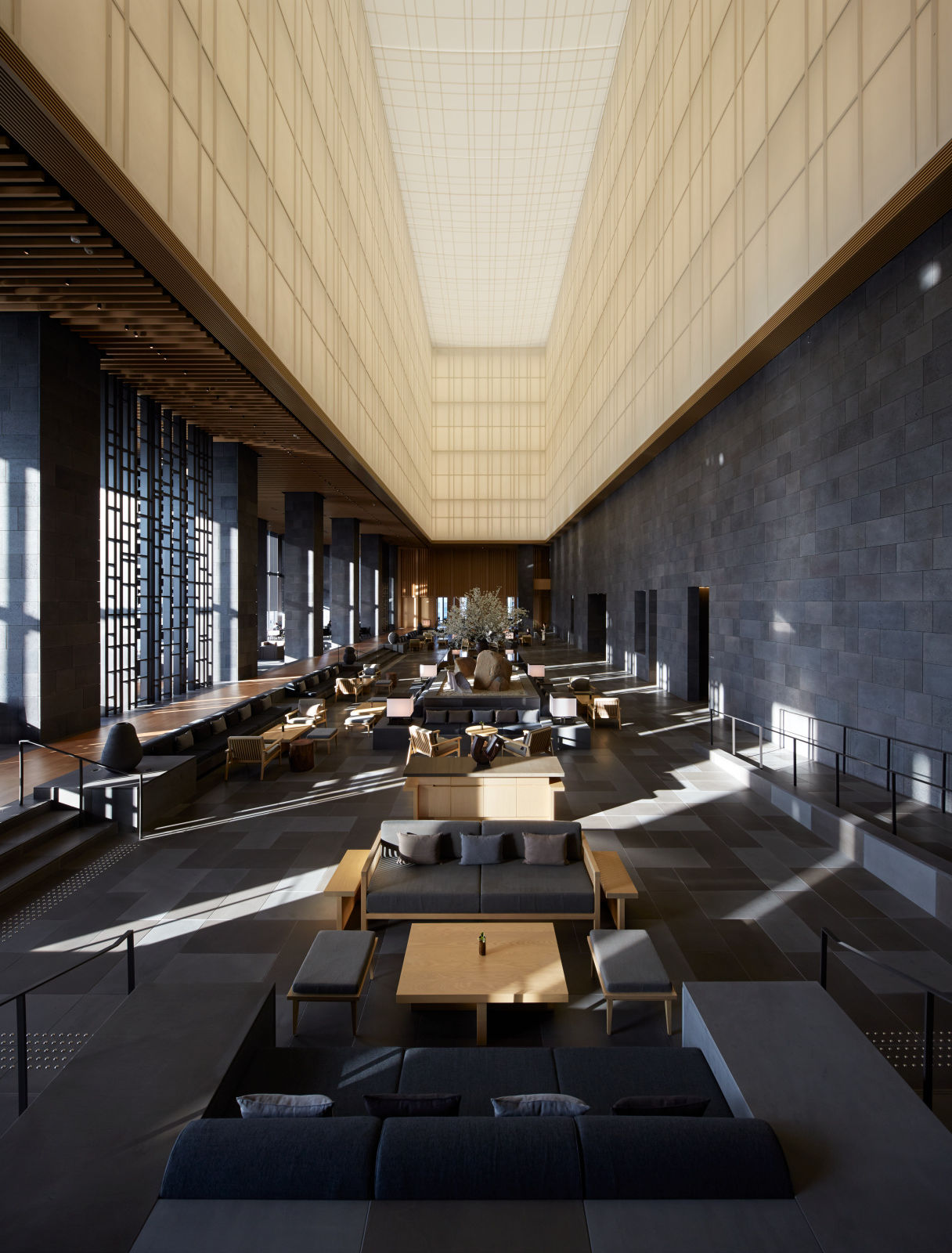 Lengthwise view of Aman Tokyo lobby under the washi lantern with engawa walkway and rock gardens