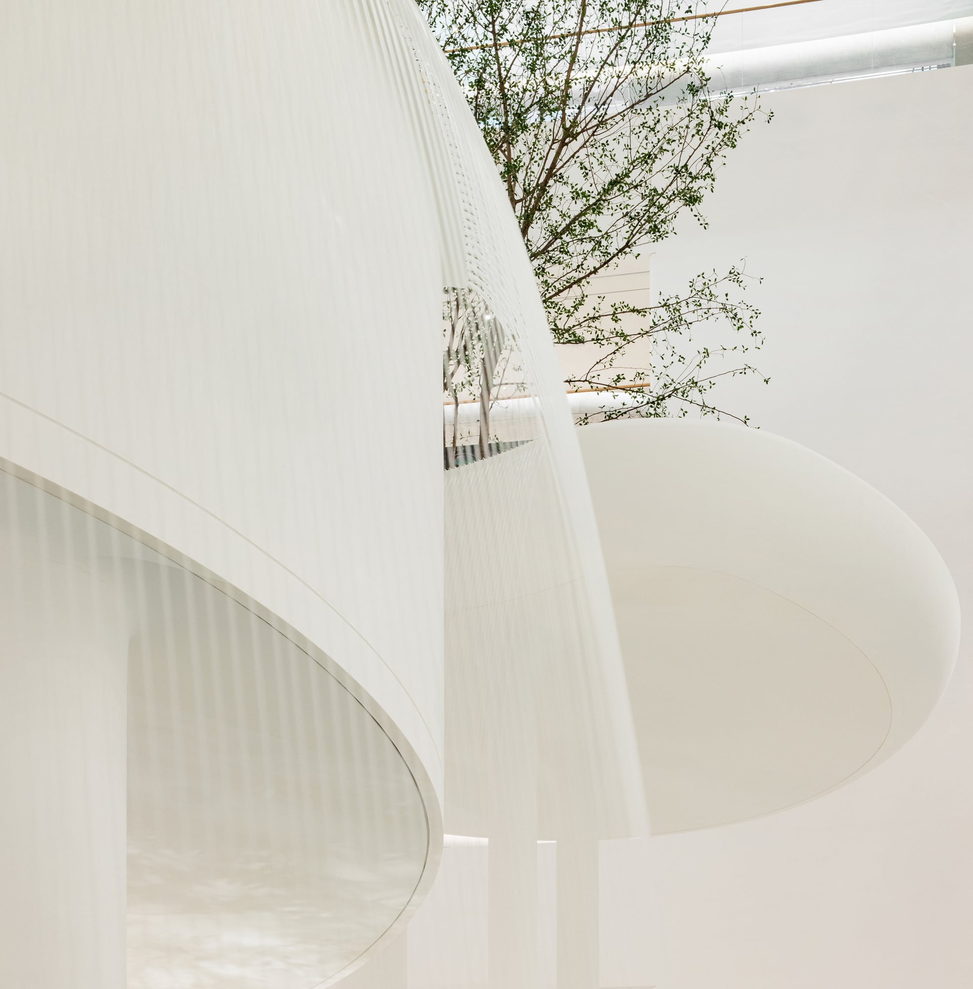 Looking up through floating white platforms and falling water in the Waterfall Garden
