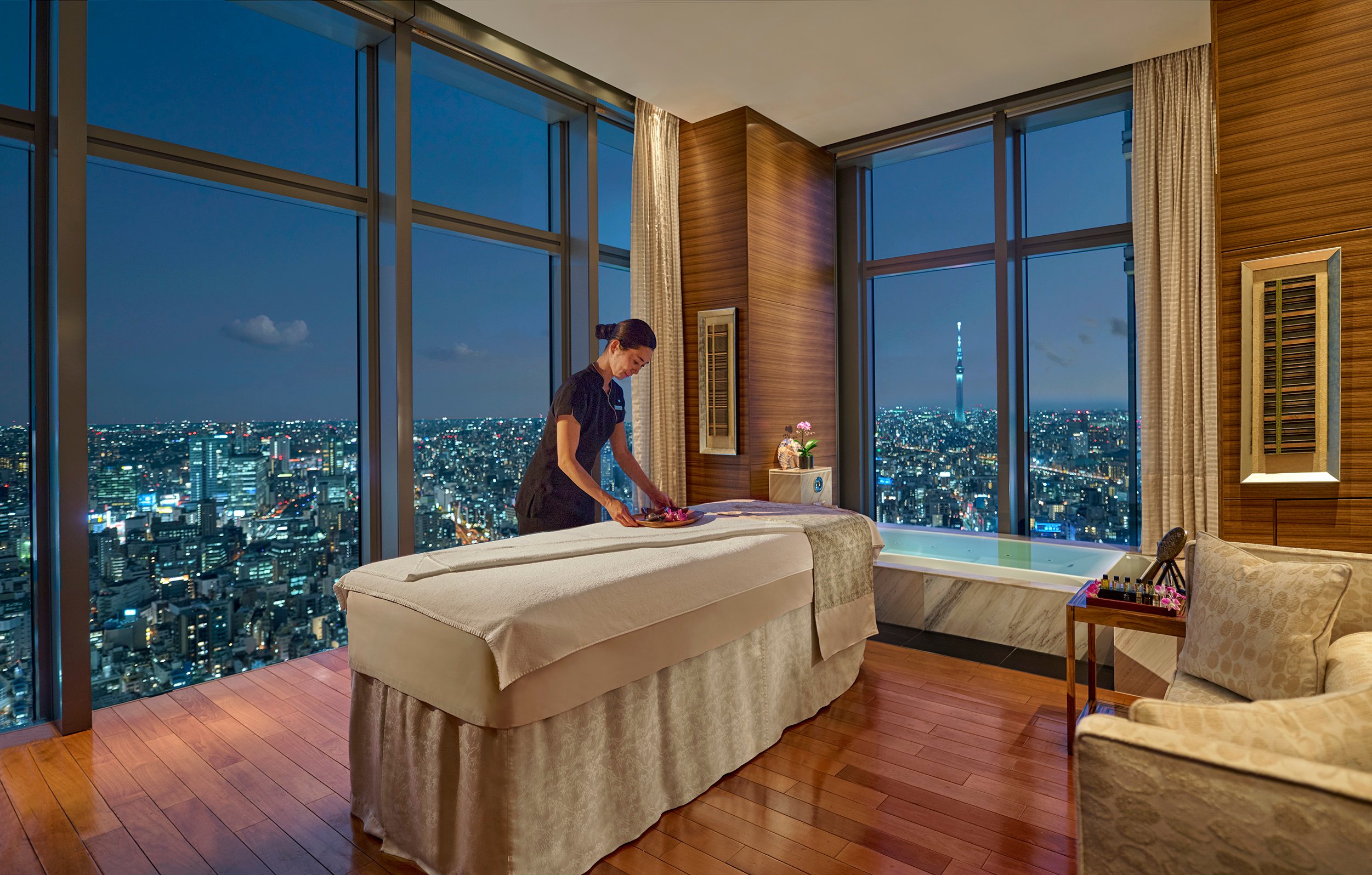 A treatment room at Mandarin Oriental, Tokyo, with Tokyo Skytree beyond the glass