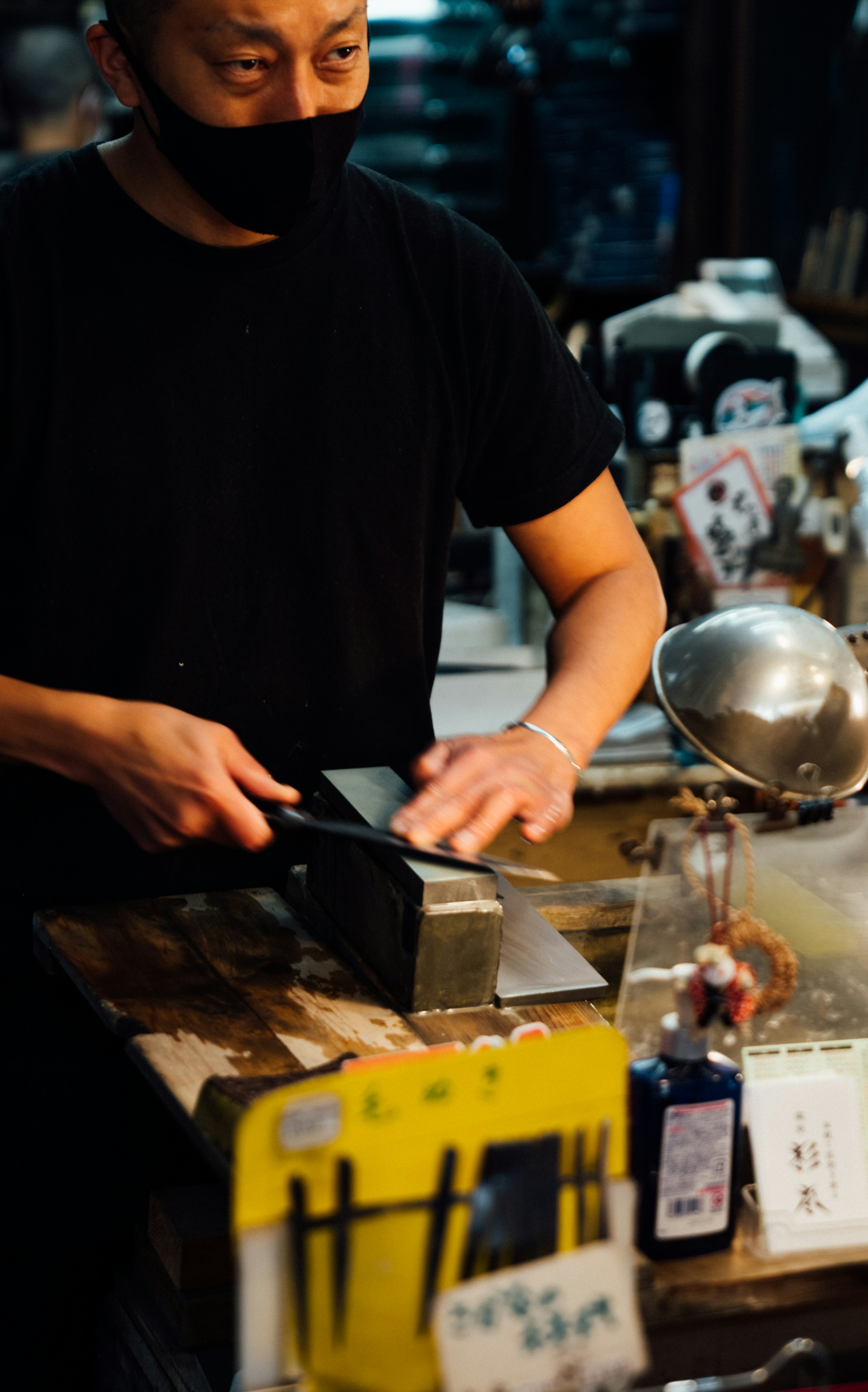 Chef preparing fish at a Tokyo sushi counter