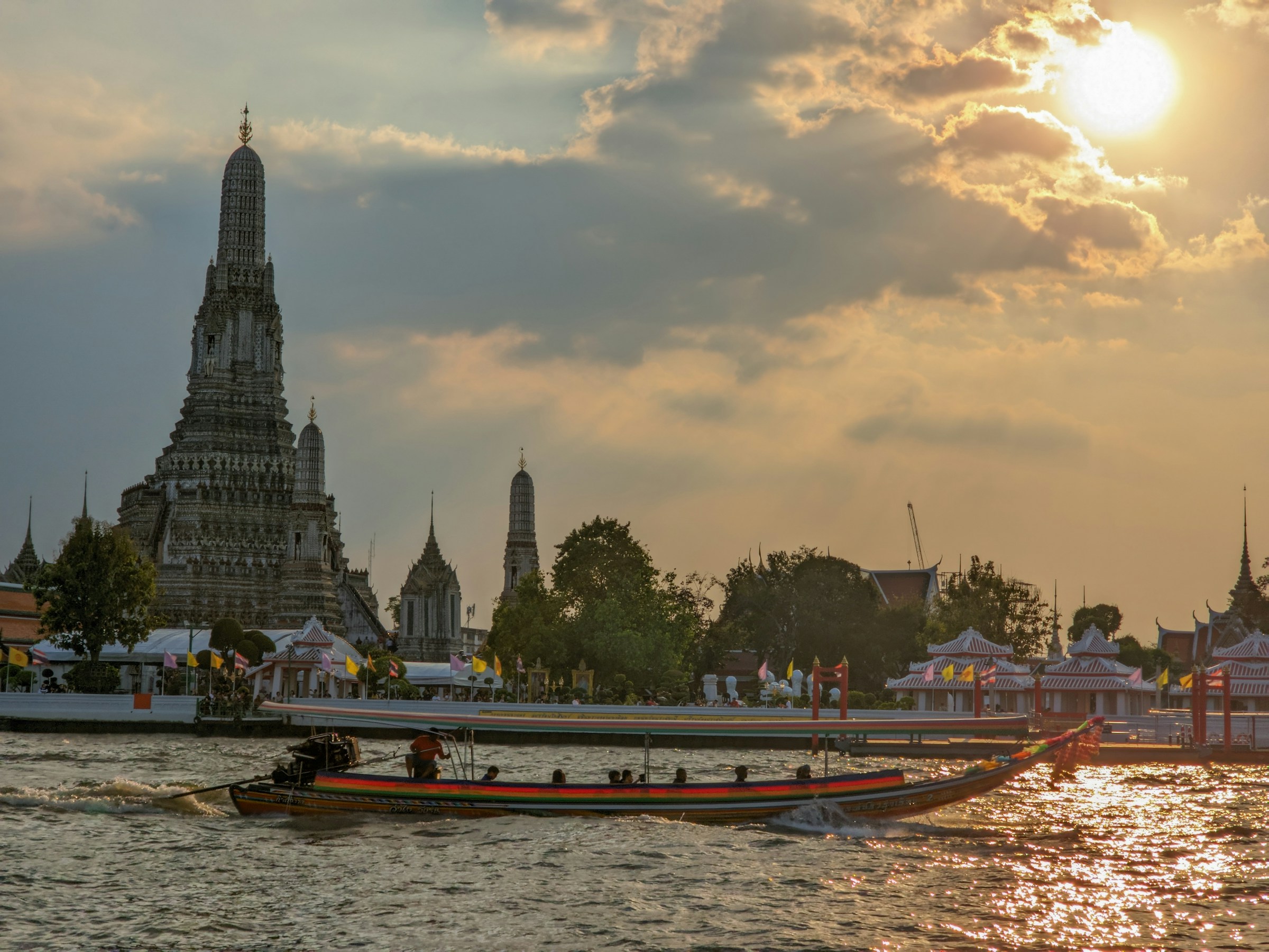 Boat on the Chao Phraya River with Wat Arun at sunset