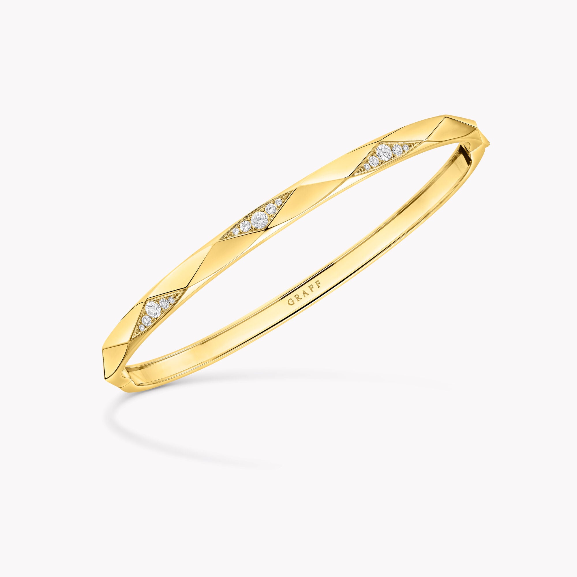 Laurence Graff Signature yellow gold faceted bangle with triangular pavé diamond panels, Graff engraving visible inside