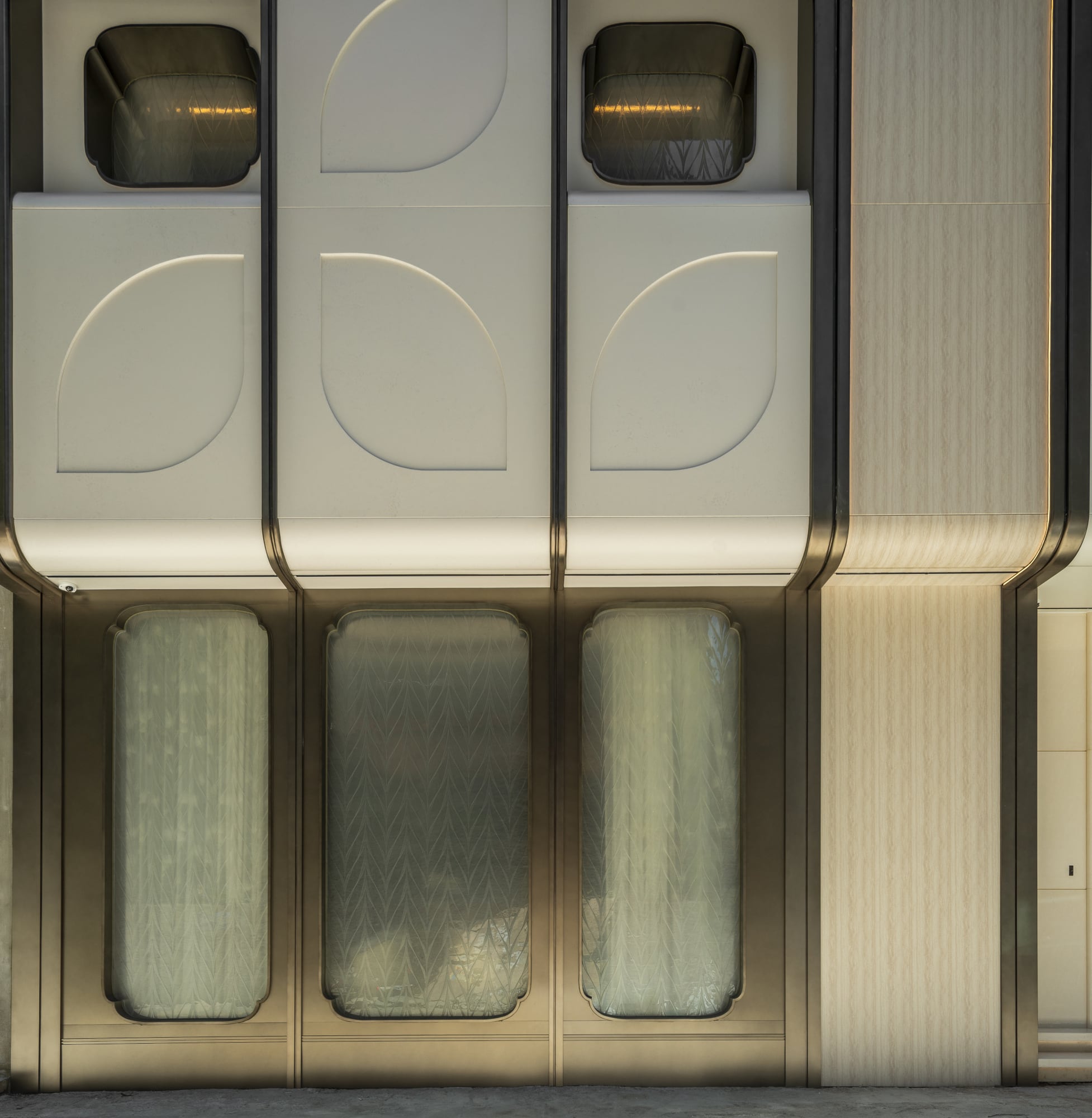 Tate facade on Lok Ku Road with bronze frames and leaf panels