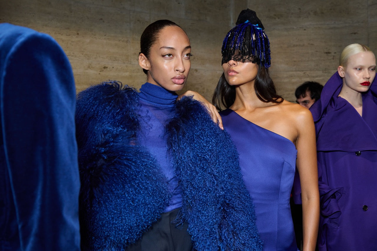 Models in jewel-toned Prabal Gurung Fall 2026 looks, including a beaded lace headpiece