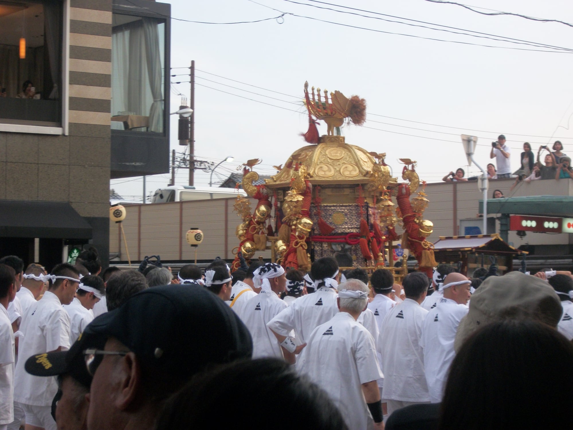 A tall Yamahoko float pulled through central Kyoto during Gion Matsuri