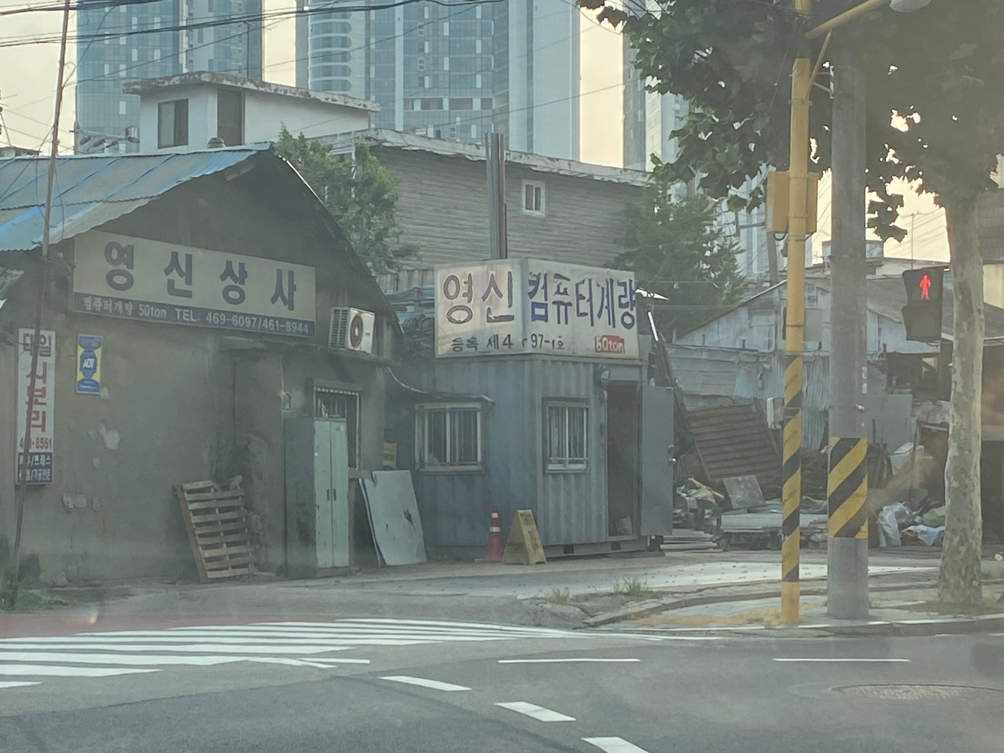 Industrial street corner in Seongsu-dong, Seoul, with high-rises beyond