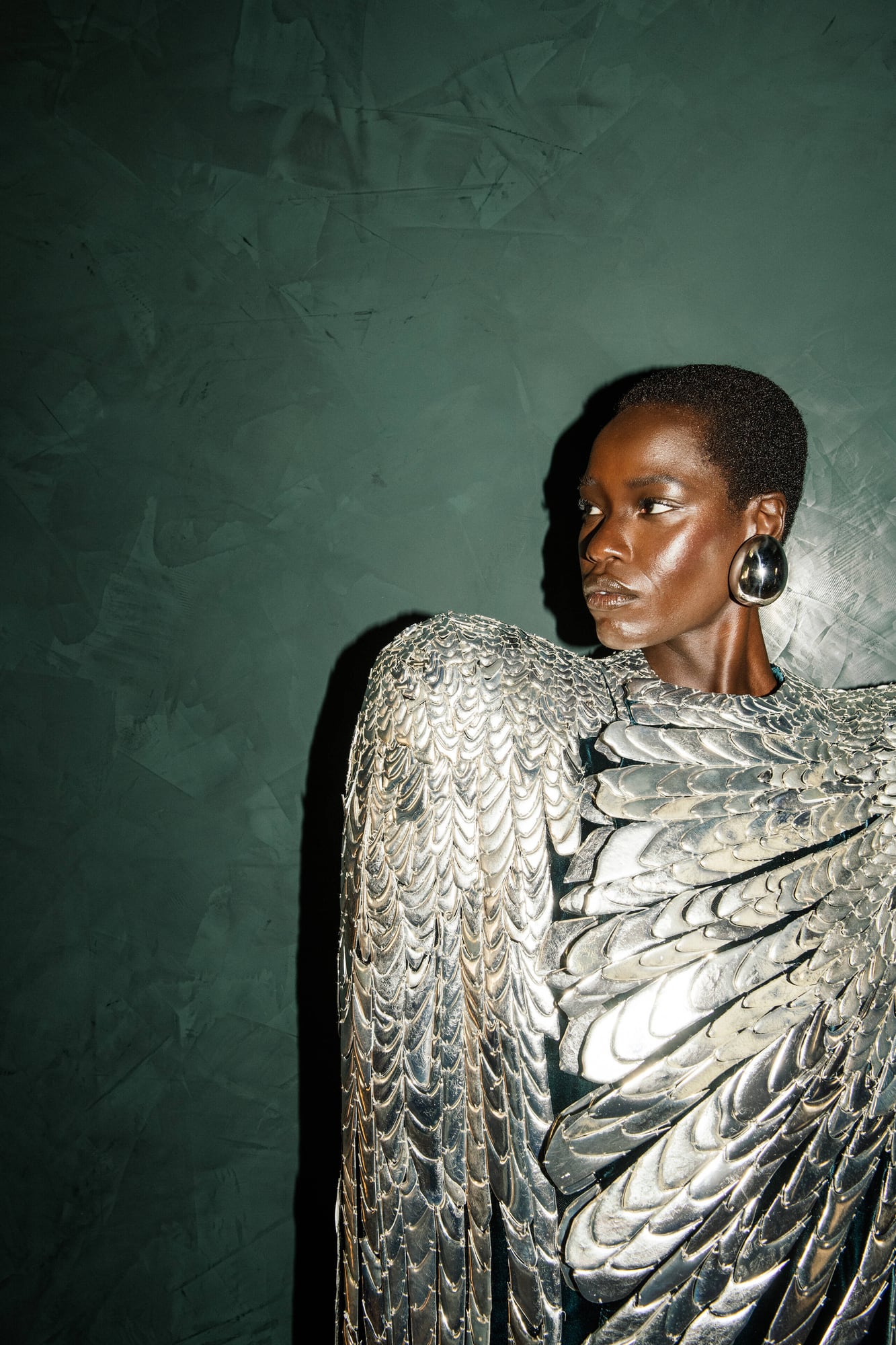 Model Awar Odhiang in Schiaparelli haute couture autumn/winter 2024 metallic silver feathered look