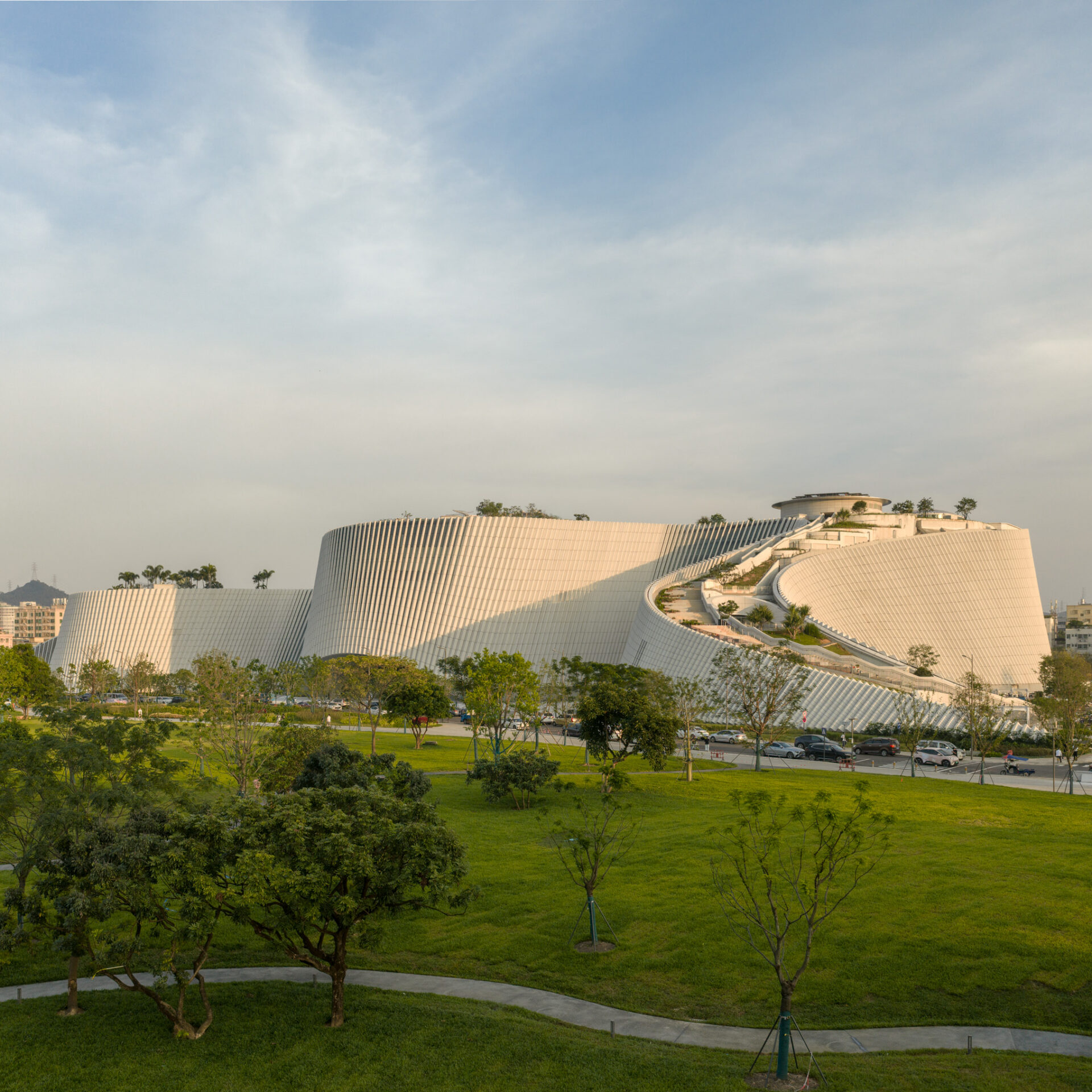 Interior volume of Shenzhen Natural History Museum with layered galleries and daylight from the terrain-form roof