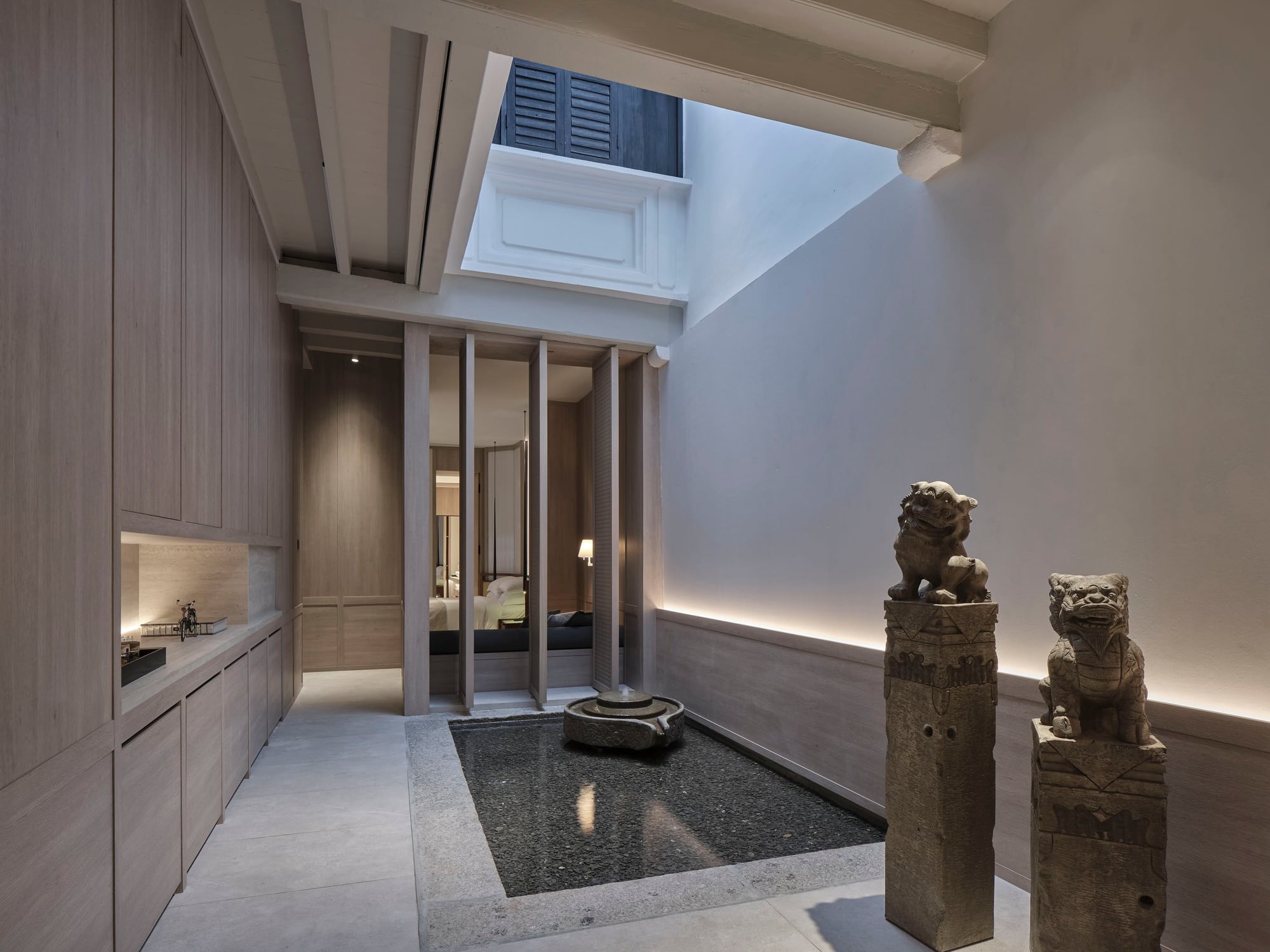 Soori Penang suite lightwell with pebble pool and stone lions