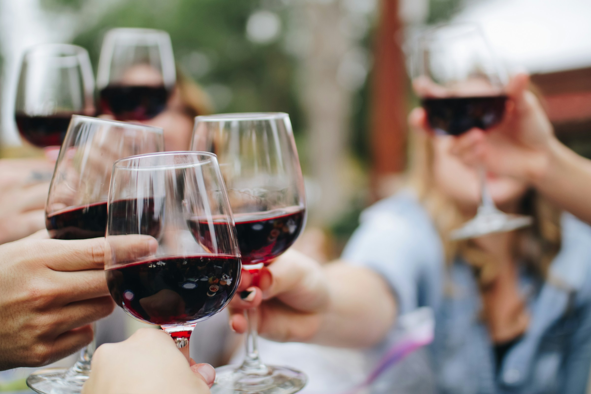 Wine glasses raised in a celebratory toast
