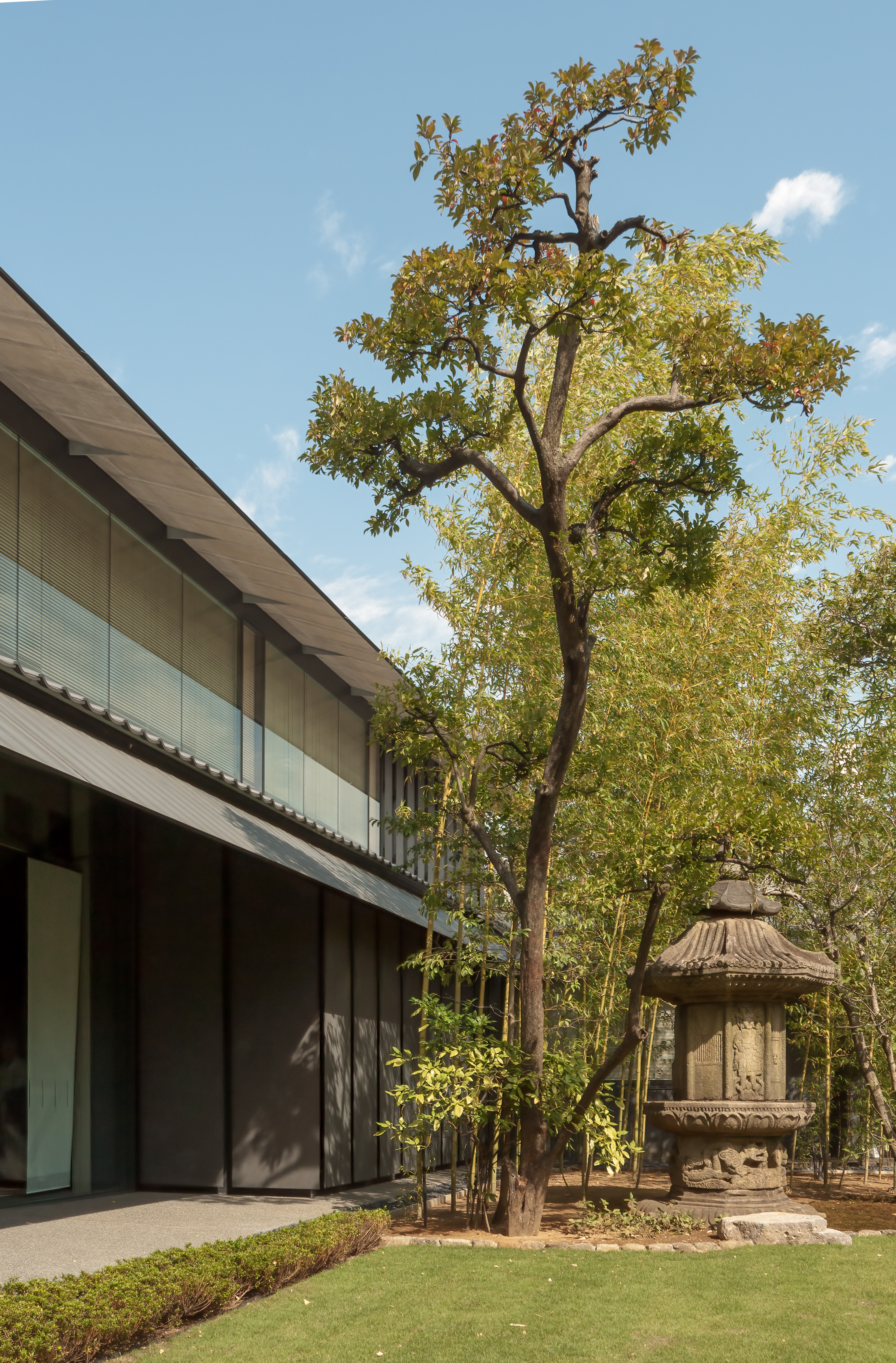 Nezu Museum garden façade with bamboo and stone lantern