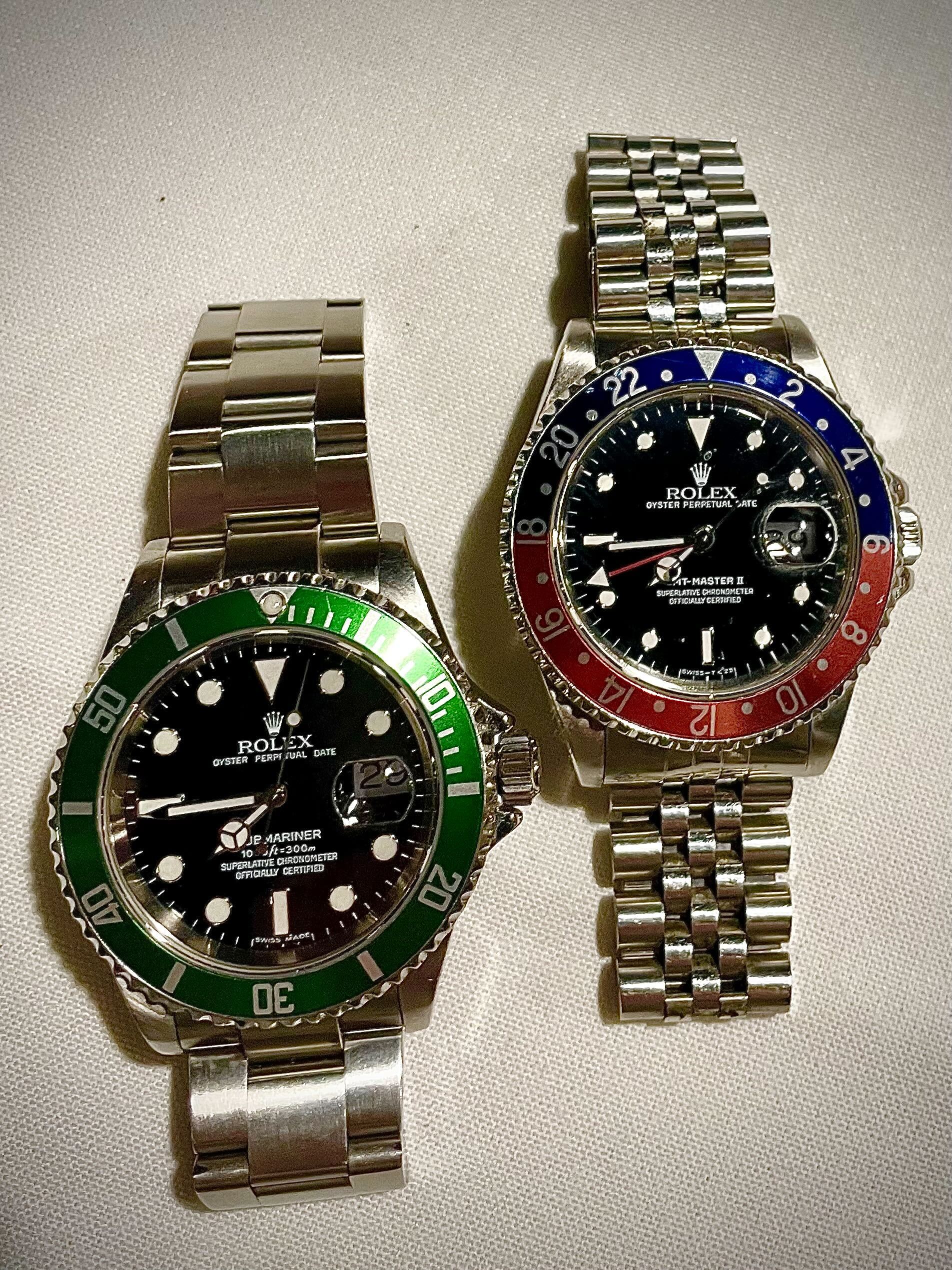 A green-bezel Submariner beside a GMT-Master II