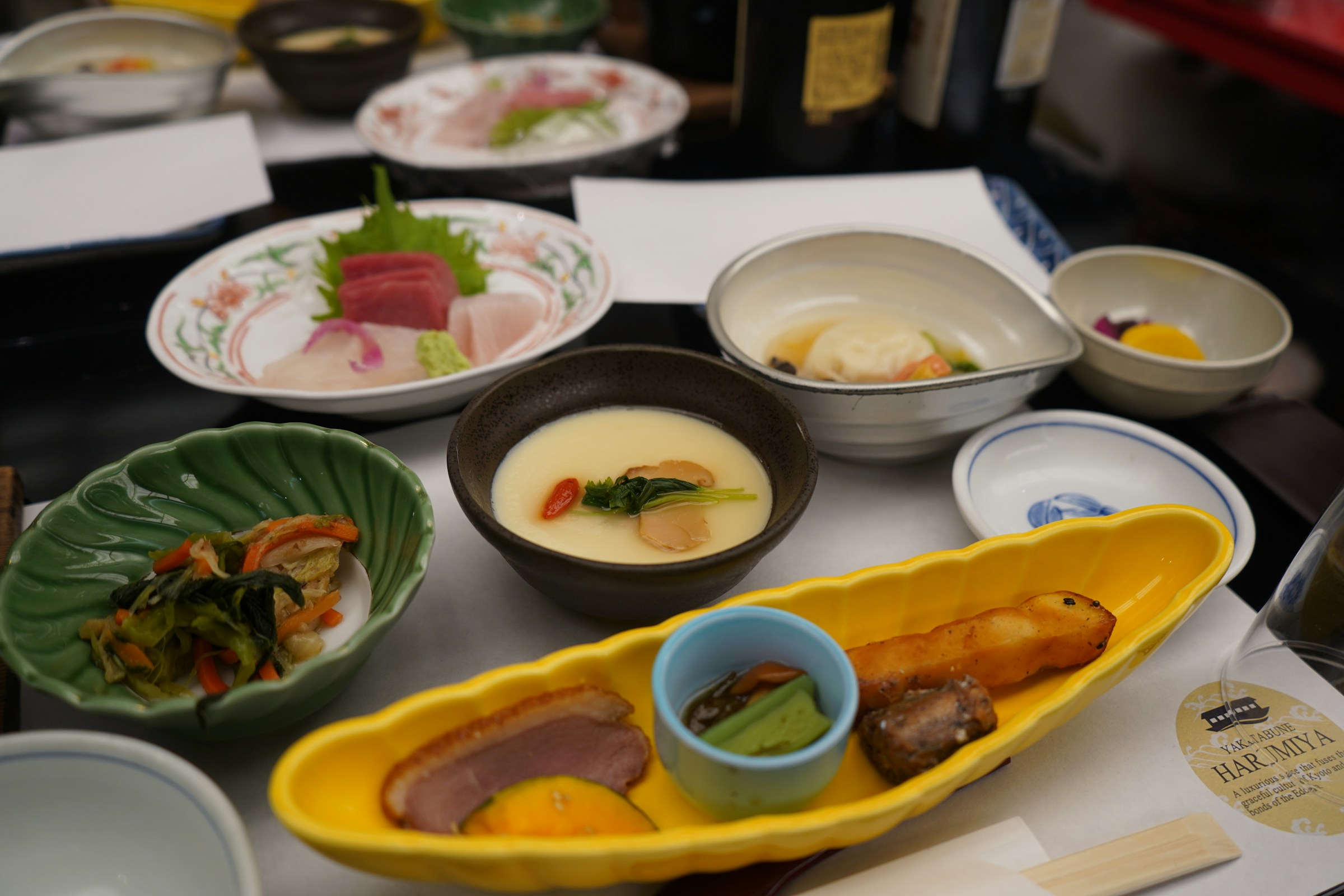 Multi-course kaiseki dinner with seasonal Japanese dishes on lacquerware