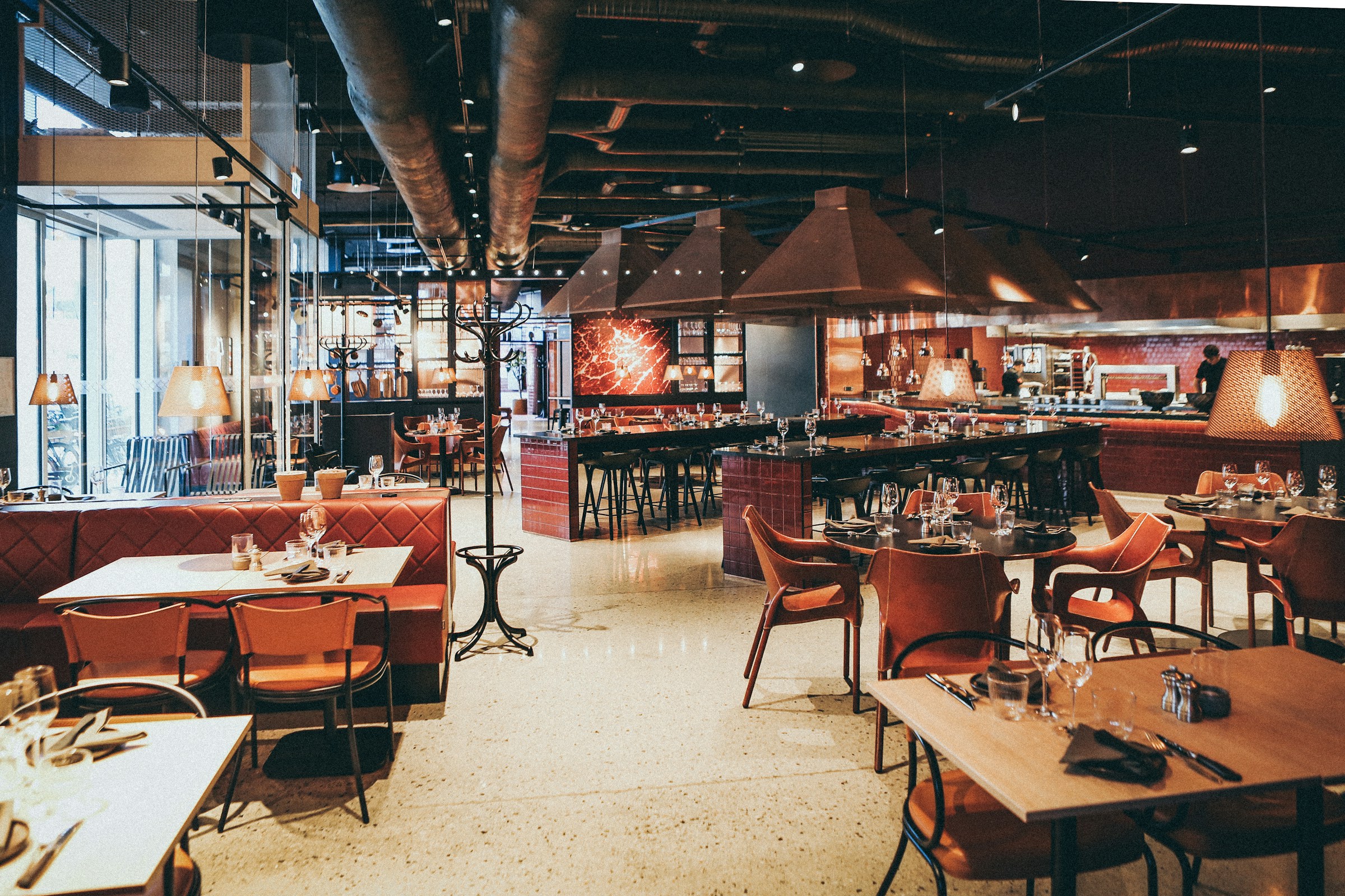Upscale restaurant dining room with wine glasses on each table